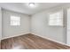 Comfortable bedroom with wood-look floors, neutral paint and natural light at 5032 Central Church Rd, Douglasville, GA 30135