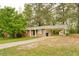 View of a one-story brick home with a carport and a storage shed in the backyard at 5032 Central Church Rd, Douglasville, GA 30135