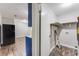 Functional laundry room with wood flooring, shelving, and access to the kitchen area at 5032 Central Church Rd, Douglasville, GA 30135