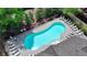 Aerial view of community pool surrounded by trees, lounge chairs, and a secure fence at 1372 Doublegate Dr, Atlanta, GA 30319