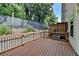A large wooden deck featuring a dark metal and wood railing, perfect for outdoor enjoyment and entertaining at 1372 Doublegate Dr, Atlanta, GA 30319