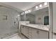 Bathroom featuring double vanity, marble counters, and glass shower at 1372 Doublegate Dr, Atlanta, GA 30319