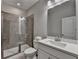 A bathroom with a glass-enclosed shower and a white vanity with a bright, modern aesthetic at 1372 Doublegate Dr, Atlanta, GA 30319