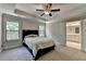 Bedroom featuring neutral walls, carpet, ceiling fan and ensuite bath at 1372 Doublegate Dr, Atlanta, GA 30319