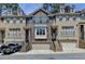 Charming brick townhome featuring a two-car garage, well-maintained landscaping, and inviting front entrances at 1372 Doublegate Dr, Atlanta, GA 30319