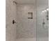 Shower with marble-style tiling and built-in shelf and a rainfall shower head at 1372 Doublegate Dr, Atlanta, GA 30319