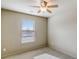 Simple, carpeted bedroom with a single window and ceiling fan at 2722 Sardis Chase Ct, Buford, GA 30519