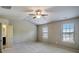 Large bedroom with plush carpet, two windows, and neutral color scheme at 2722 Sardis Chase Ct, Buford, GA 30519