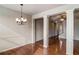 Elegant dining room featuring hardwood floors, decorative columns, and a modern chandelier at 2722 Sardis Chase Ct, Buford, GA 30519