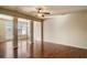 Open-concept living space with hardwood floors, decorative columns, and large windows providing ample natural light at 2722 Sardis Chase Ct, Buford, GA 30519