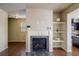 Inviting living room featuring a fireplace, built-in shelving, and access to the kitchen at 2722 Sardis Chase Ct, Buford, GA 30519