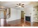 Cozy living room features hardwood floors, a fireplace with a mantle, and access to the backyard at 2722 Sardis Chase Ct, Buford, GA 30519