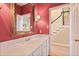Bathroom features a white vanity, large mirror, and a view towards the staircase at 415 Westlake Nw Ct, Marietta, GA 30064
