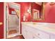 Bathroom with white cabinets, a large mirror, and a shower-tub combo at 415 Westlake Nw Ct, Marietta, GA 30064