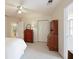 A bright bedroom is furnished with wooden dressers and features carpeted floors and a bright white door at 415 Westlake Nw Ct, Marietta, GA 30064