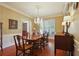 Elegant dining room with a chandelier, wood table set for six, and beautiful wall decor at 415 Westlake Nw Ct, Marietta, GA 30064