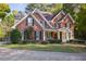 Elegant two-story brick home featuring a welcoming front porch and beautifully landscaped front yard at 415 Westlake Nw Ct, Marietta, GA 30064