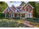 Attractive brick home with a cozy front porch, perfect for relaxing and enjoying the serene surroundings at 415 Westlake Nw Ct, Marietta, GA 30064