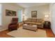 Cozy living room with comfortable seating, hardwood floors, and natural light from the window at 415 Westlake Nw Ct, Marietta, GA 30064