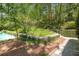 Lush backyard and walkway by the pool with beautiful greenery at 1105 Crest Valley Dr, Sandy Springs, GA 30327