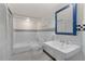 Bathroom featuring tiled shower, sink, and checkerboard wall design at 1105 Crest Valley Dr, Sandy Springs, GA 30327
