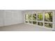 Bright bedroom featuring closet and large windows with forest views at 1105 Crest Valley Dr, Sandy Springs, GA 30327