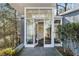 Stylish home entrance featuring glass doors, stone floors, and a modern design at 1105 Crest Valley Dr, Sandy Springs, GA 30327