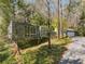 Exterior view of the house and garage surrounded by mature trees and landscaping at 1105 Crest Valley Dr, Sandy Springs, GA 30327