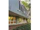 Modern home featuring a stone foundation, expansive windows, and sleek architectural design nestled in a wooded landscape at 1105 Crest Valley Dr, Sandy Springs, GA 30327