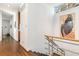 Hallway with stairs featuring modern art and a view into the hallway at 1105 Crest Valley Dr, Sandy Springs, GA 30327