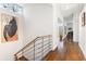 Hallway with hardwood floors leading past modern art to the living space with grand piano at 1105 Crest Valley Dr, Sandy Springs, GA 30327