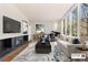 Bright living room with sleek fireplace, grand piano, and modern furnishings at 1105 Crest Valley Dr, Sandy Springs, GA 30327