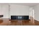 An open-concept living area featuring a sleek, modern fireplace with black stone at 1105 Crest Valley Dr, Sandy Springs, GA 30327