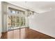 Open living space featuring hardwood floors, floor-to-ceiling windows, and sliding glass door at 1105 Crest Valley Dr, Sandy Springs, GA 30327