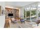 Living room featuring built-in bookshelves, hardwood floors, and a sliding glass door at 1105 Crest Valley Dr, Sandy Springs, GA 30327