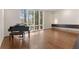 Spacious living room with hardwood floors, floor-to-ceiling windows, and a grand piano at 1105 Crest Valley Dr, Sandy Springs, GA 30327