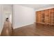 Spacious area featuring hardwood floors, an open floor plan, and a built-in bookshelf at 1105 Crest Valley Dr, Sandy Springs, GA 30327