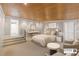 This main bedroom boasts a wood plank ceiling and an ensuite bathroom at 1105 Crest Valley Dr, Sandy Springs, GA 30327
