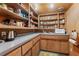 Well-stocked pantry with wood shelving and countertop space at 1105 Crest Valley Dr, Sandy Springs, GA 30327