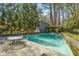 Sparkling swimming pool surrounded by a stone patio and lush landscaping at 1105 Crest Valley Dr, Sandy Springs, GA 30327