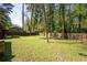 Large, fenced backyard with mature trees providing shade and privacy, perfect for outdoor activities at 1650 Randee Nw St, Atlanta, GA 30318