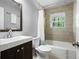 Modern bathroom features a new vanity, a toilet, and a shower with a tub at 1650 Randee Nw St, Atlanta, GA 30318