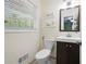 Bathroom with a wood vanity, toilet, and window that offers natural light at 1650 Randee Nw St, Atlanta, GA 30318