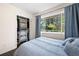 Well-lit bedroom offers a closet and views of the exterior trees at 1650 Randee Nw St, Atlanta, GA 30318