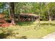 Well-maintained single-story brick home features a covered front porch, and mature landscaping at 1650 Randee Nw St, Atlanta, GA 30318