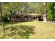 Charming brick ranch-style home with a well-manicured lawn and mature trees at 1650 Randee Nw St, Atlanta, GA 30318