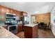 A bright kitchen and breakfast area features granite countertops and wooden cabinets at 1650 Randee Nw St, Atlanta, GA 30318