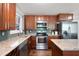 A modern kitchen features granite countertops, stainless steel appliances, and wooden cabinets at 1650 Randee Nw St, Atlanta, GA 30318