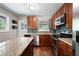 An open kitchen layout featuring an island, stainless steel appliances, and wooden cabinets at 1650 Randee Nw St, Atlanta, GA 30318