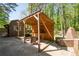 Outdoor kitchen features a wooden pergola, brick firepit, seating, and is perfect for entertaining at 1650 Randee Nw St, Atlanta, GA 30318